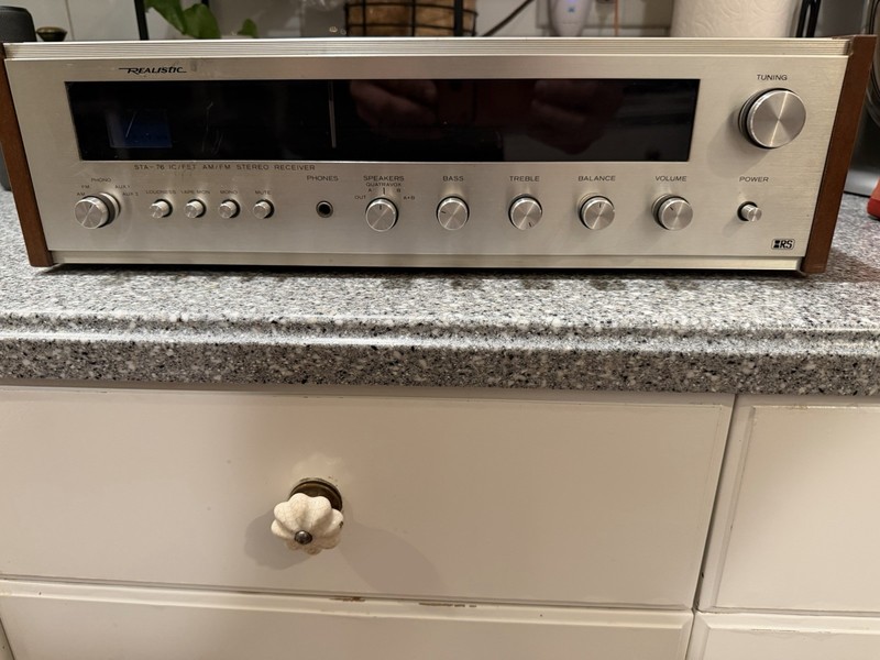 Realistic STA-76 was a silver-fronted stereo receiver with a walnut-grained