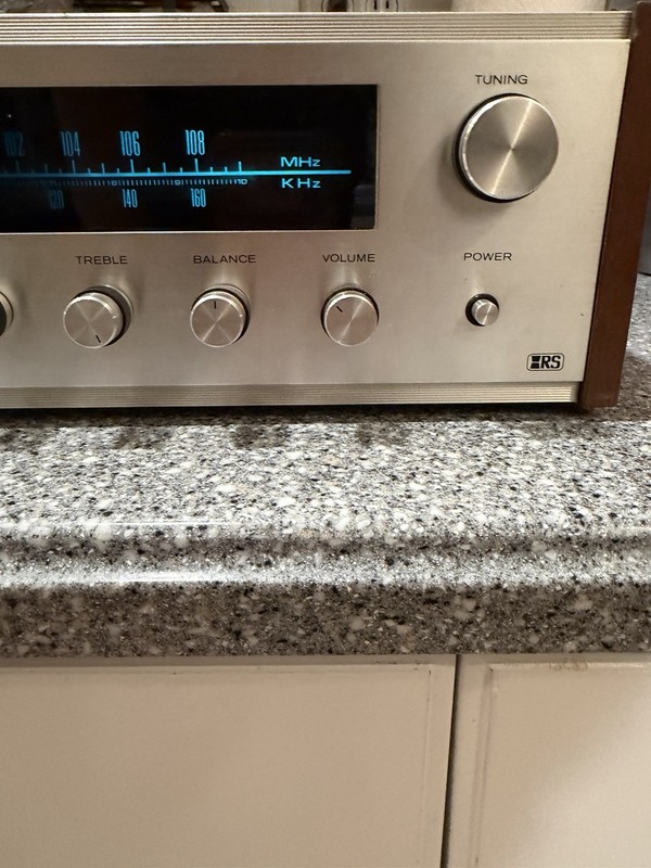 Realistic STA-76 was a silver-fronted stereo receiver with a walnut-grained gallery